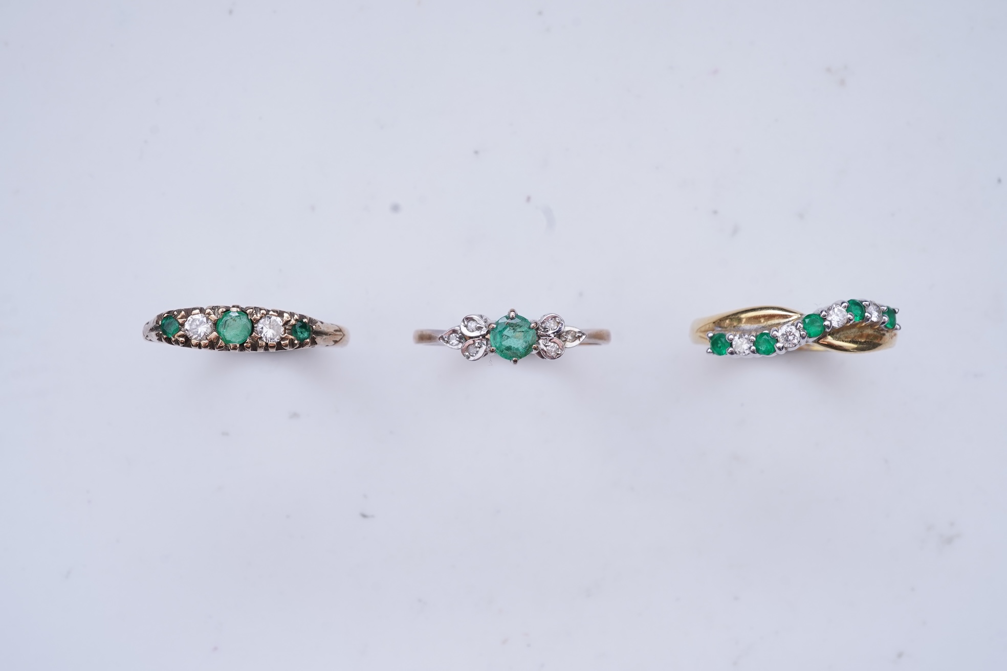 Three emerald and diamond rings